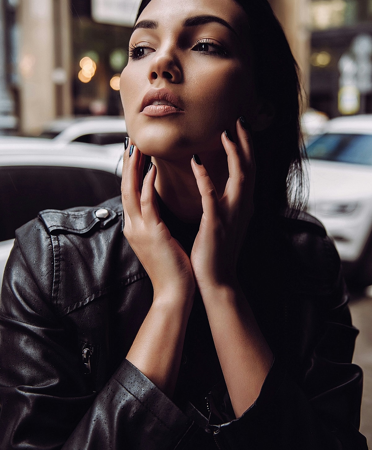 Bakersfield Facial Balancing model posing thoughtfully in urban setting.
